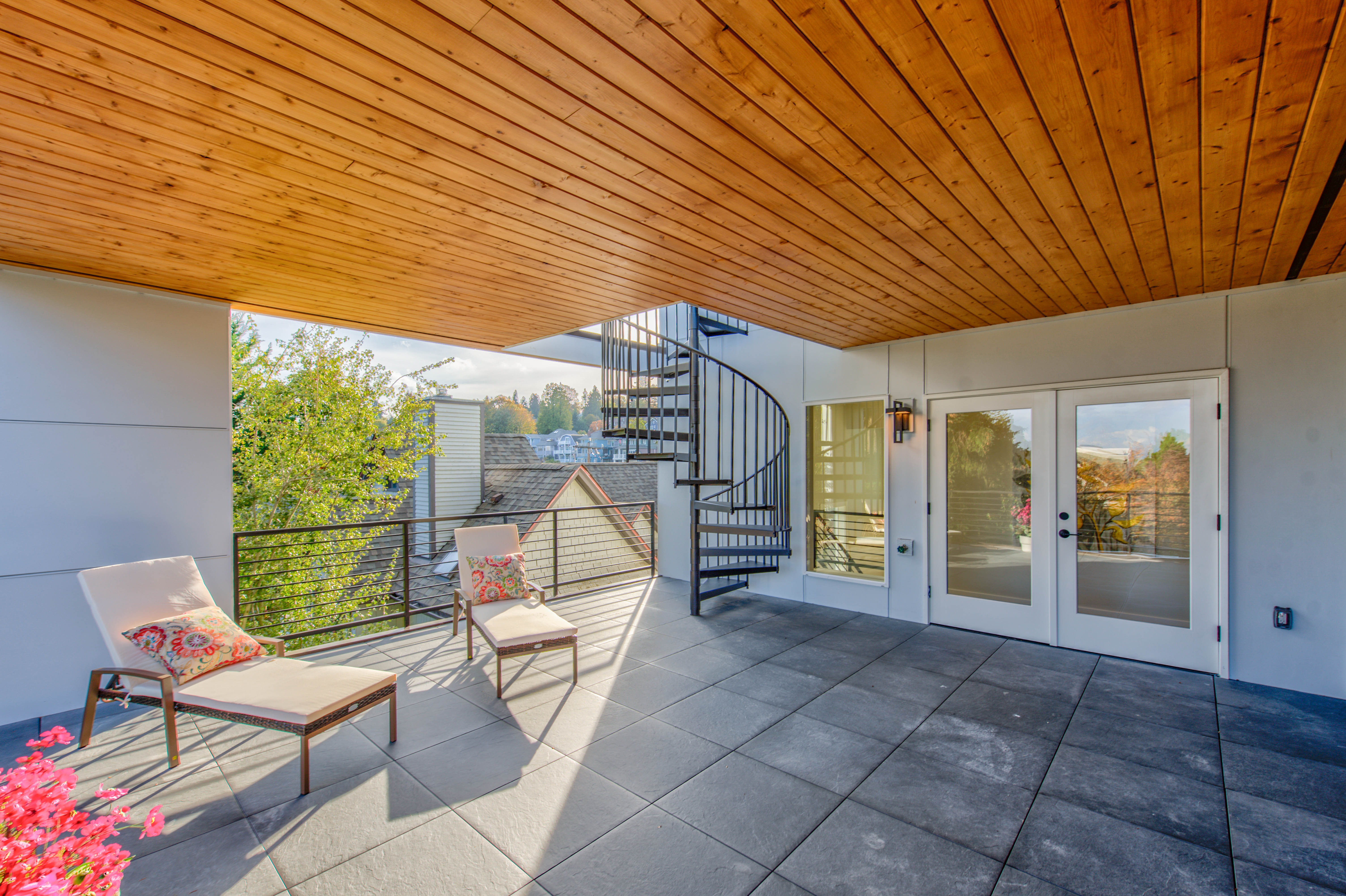 A beautiful covered patio with stone tile floor.